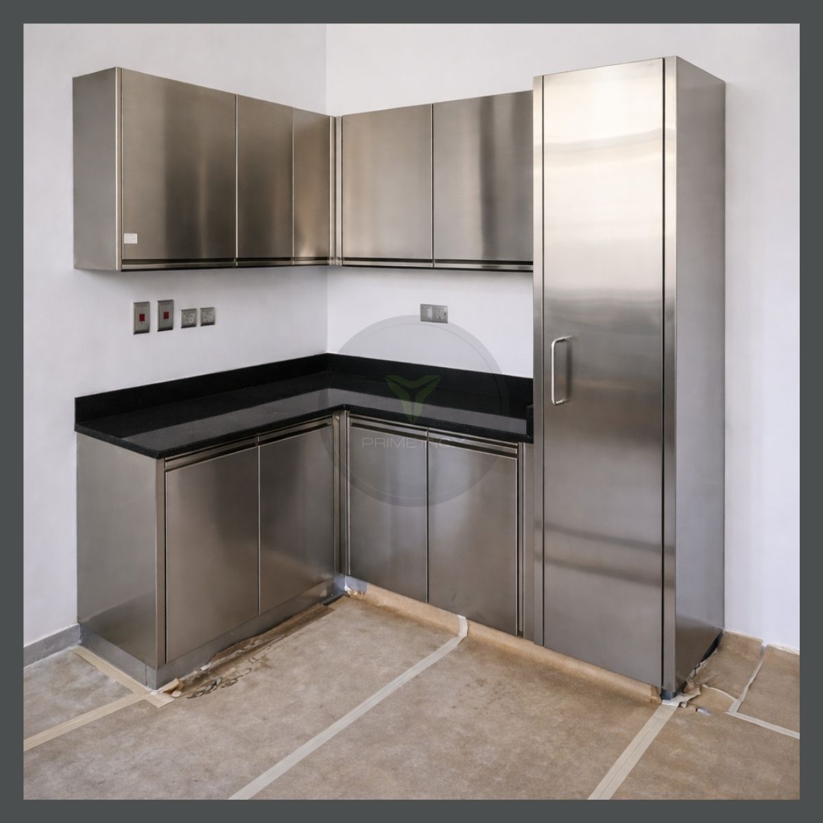 Modern stainless steel kitchen interior with modular wall and base cabinets, seamless storage units, and hygienic work surfaces designed for commercial and institutional use.